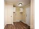 Small laundry room with storage cabinets, white doors and wood-look flooring at 155 Springdale Acres Dr, Mooresville, NC 28115
