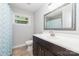This bathroom features a vanity with a framed mirror and a shower with a blue curtain at 1632 Charles Raper Jonas Hwy, Mount Holly, NC 28120