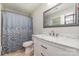 This bathroom features a shower with a patterned curtain and a vanity with a marble countertop at 1632 Charles Raper Jonas Hwy, Mount Holly, NC 28120