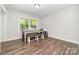 This dining room features laminate flooring, a large window, and a rustic table with bench seating at 1632 Charles Raper Jonas Hwy, Mount Holly, NC 28120