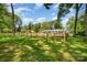 Inviting front yard with a rustic fence and a charming single-story home at 1632 Charles Raper Jonas Hwy, Mount Holly, NC 28120