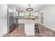 Bright kitchen featuring stainless steel appliances, an island with bar stools, and granite countertops at 1632 Charles Raper Jonas Hwy, Mount Holly, NC 28120