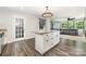 Open concept kitchen features granite countertops, an island, and seamless access to the living area at 1632 Charles Raper Jonas Hwy, Mount Holly, NC 28120