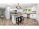 Bright kitchen features stainless steel appliances, granite countertops, and a convenient island with seating at 1632 Charles Raper Jonas Hwy, Mount Holly, NC 28120