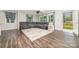Bright living room featuring a plush sectional couch, stylish rug, and ample natural light at 1632 Charles Raper Jonas Hwy, Mount Holly, NC 28120