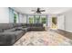 Inviting living room featuring a comfortable sectional, modern flooring, and scenic outdoor views at 1632 Charles Raper Jonas Hwy, Mount Holly, NC 28120