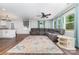 Inviting living room with a gray sofa, decorative rug, and natural light streaming through the windows at 1632 Charles Raper Jonas Hwy, Mount Holly, NC 28120