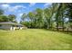 Expansive green lawn framed by mature trees and a rustic wooden fence, offering a serene setting at 1632 Charles Raper Jonas Hwy, Mount Holly, NC 28120