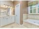 Charming bathroom features a soaking tub, tile flooring, and a vanity with ample storage space at 187 Spring Run Dr, Mooresville, NC 28117
