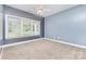 Cozy bedroom with carpet floors, a large window with blinds, and a ceiling fan at 187 Spring Run Dr, Mooresville, NC 28117