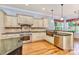 An open kitchen featuring an island, granite countertops, stainless appliances, and ample custom wood cabinetry at 187 Spring Run Dr, Mooresville, NC 28117