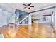 Open living area with hardwood floors, staircase and adjacent kitchen at 187 Spring Run Dr, Mooresville, NC 28117