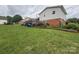 Exterior backyard view, which includes a lawn, deck, and garden at 1895 Sandy Cir, Newton, NC 28658