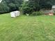 Backyard with a storage shed and a spacious lawn at 1895 Sandy Cir, Newton, NC 28658
