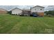 Expansive backyard with lush green lawn, a deck, and charming landscaping at 1895 Sandy Cir, Newton, NC 28658