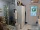 Well-lit bathroom with a glass-enclosed shower and white cabinets at 1895 Sandy Cir, Newton, NC 28658
