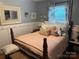 Bedroom featuring neutral walls, patterned drapes, and wood trim at 1895 Sandy Cir, Newton, NC 28658