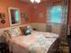 Cozy bedroom featuring a patterned quilt, decorative pillows, and a window with floral curtains at 1895 Sandy Cir, Newton, NC 28658