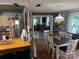 Dining area with wood floors, a decorative chandelier, and a view into the living room at 1895 Sandy Cir, Newton, NC 28658
