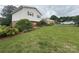 Exterior view with a brick foundation, a manicured lawn, and mature landscaping at 1895 Sandy Cir, Newton, NC 28658
