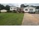 Charming home with a lush lawn, beautiful landscaping, and inviting outdoor seating area at 1895 Sandy Cir, Newton, NC 28658