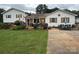 Charming home with a lush lawn, beautiful landscaping, and inviting outdoor seating area at 1895 Sandy Cir, Newton, NC 28658