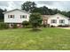 Well-maintained home with a green lawn, mature trees, and lovely curb appeal at 1895 Sandy Cir, Newton, NC 28658