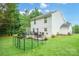 Spacious backyard featuring a patio area with a dining set, fire pit, and privacy fence at 1912 8Th Se St, Hickory, NC 28602