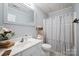 Charming bathroom featuring a vanity with a white sink and a shower with a striped curtain at 1912 8Th Se St, Hickory, NC 28602