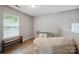Cozy bedroom featuring a window, wood floors, bench and a closet for comfortable living at 1912 8Th Se St, Hickory, NC 28602