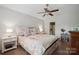 Bright bedroom with a ceiling fan, wood flooring, and a glimpse into the bathroom at 1912 8Th Se St, Hickory, NC 28602