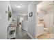 Bright hallway with hardwood floors leads to a nearby bathroom and open living space upstairs at 1912 8Th Se St, Hickory, NC 28602