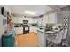 Bright kitchen featuring white cabinets and two-seater kitchen island bar at 1912 8Th Se St, Hickory, NC 28602