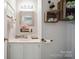 Charming half bath featuring unique decor, decorative mirror and sink with storage at 1912 8Th Se St, Hickory, NC 28602