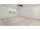Bedroom features a ceiling fan, double windows, and a white door at 2043 Sadler Woods Ln, Charlotte, NC 28214