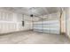 Unfinished garage with concrete floor and white garage door at 2043 Sadler Woods Ln, Charlotte, NC 28214