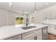 Kitchen island with modern sink and faucet with a stainless steel dishwasher and view of backyard at 2043 Sadler Woods Ln, Charlotte, NC 28214