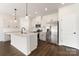 Beautiful kitchen with white cabinets, stainless steel appliances, and a large center island at 2043 Sadler Woods Ln, Charlotte, NC 28214