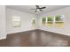 Bright living room with hardwood floors, ample windows, and a ceiling fan for year-round comfort at 2043 Sadler Woods Ln, Charlotte, NC 28214