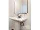 Stylish powder room with modern pedestal sink, black faucet, and framed mirror for a sleek, contemporary design at 2043 Sadler Woods Ln, Charlotte, NC 28214