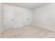 A neutral bedroom with neutral carpet has two doors, one being a closet at 2051 Sadler Woods Ln, Charlotte, NC 28214