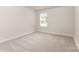 Empty bedroom with a window, carpet floors, and neutral paint at 2051 Sadler Woods Ln, Charlotte, NC 28214