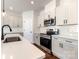 A well-equipped kitchen boasting stainless steel appliances, white subway tile backsplash, and white cabinets at 2051 Sadler Woods Ln, Charlotte, NC 28214