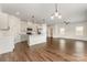 Open concept kitchen with white cabinets, stainless steel appliances, and a large island with pendant lighting at 2051 Sadler Woods Ln, Charlotte, NC 28214