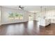 Bright and airy living room with large windows, ceiling fan, and seamless flow into the modern kitchen area at 2051 Sadler Woods Ln, Charlotte, NC 28214