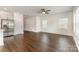 A living room with ample natural light and an open floor plan featuring hardwood floors and a modern kitchen nearby at 2051 Sadler Woods Ln, Charlotte, NC 28214