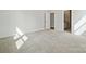 Neutral bedroom featuring plush carpet, base molding, and two doorways, one leading to an ensuite bathroom at 21013 Running Creek Dr # 4, Locust, NC 28097