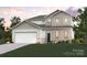 Charming new construction two-story home with gray and white accents, lush yard, and two-car garage at 21013 Running Creek Dr # 4, Locust, NC 28097