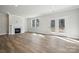 Open living room with a fireplace and large doors to the backyard, letting in ample natural light at 21013 Running Creek Dr # 4, Locust, NC 28097