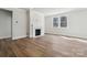 Cozy living room featuring a stylish fireplace and a large window with natural light at 21013 Running Creek Dr # 4, Locust, NC 28097